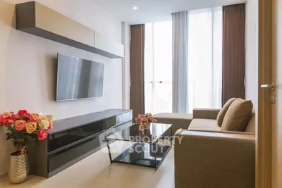 Modern living room with sleek furniture and large TV, perfect for relaxation.