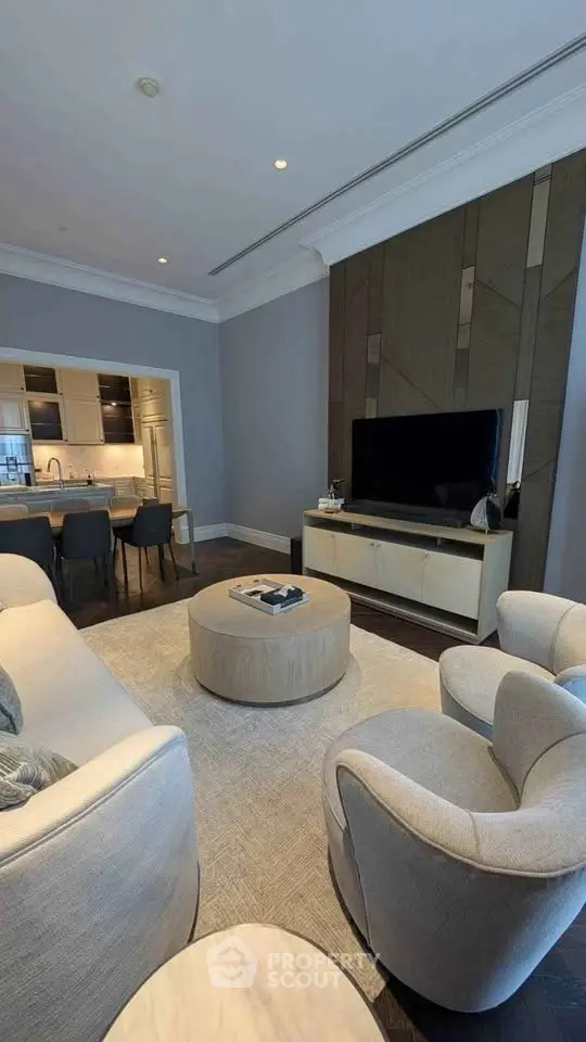 Luxurious living room with modern furniture and open kitchen layout, perfect for entertaining.