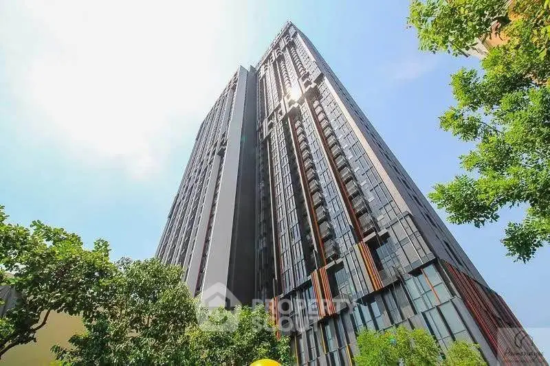 Stunning high-rise building with modern architecture and lush greenery