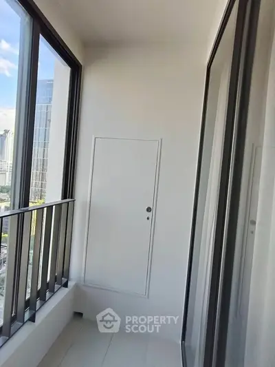 Modern balcony with city view and sleek glass doors