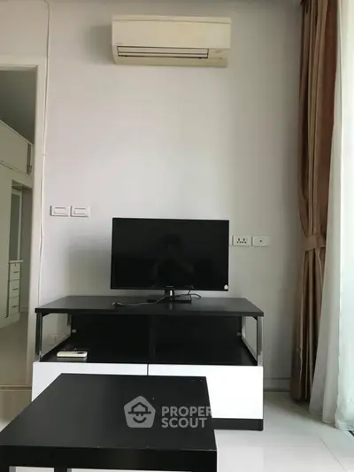 Modern living room with air conditioning and sleek TV setup