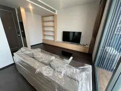 Modern living room with sleek TV setup and large window view.