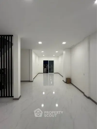 Spacious modern interior with sleek white flooring and minimalist design, perfect for contemporary living.