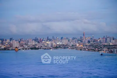 Stunning city skyline view from rooftop infinity pool at dusk, perfect for luxury urban living.