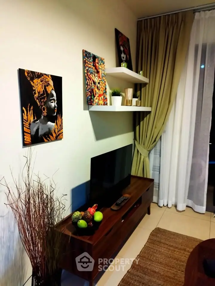 Stylish living room with modern decor and wall art, featuring a sleek TV setup.