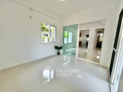 Spacious modern living room with glossy tile flooring and large windows