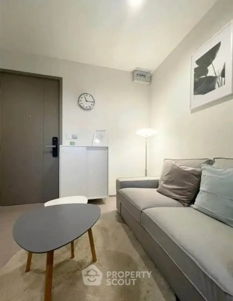 Cozy modern living room with stylish sofa and coffee table, perfect for relaxation.