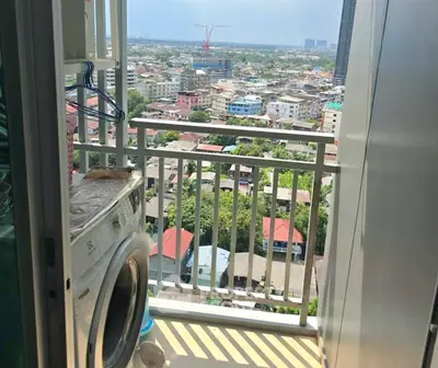 Charming balcony with city view and laundry area in modern apartment