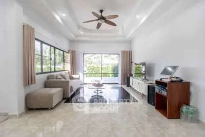 Spacious modern living room with large windows and stylish ceiling fan