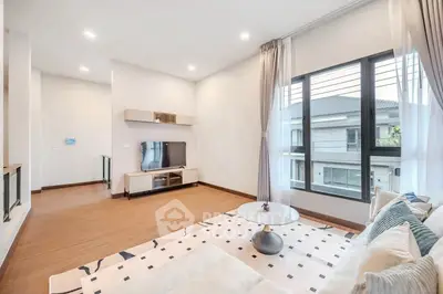 Spacious modern living room with large window and elegant decor