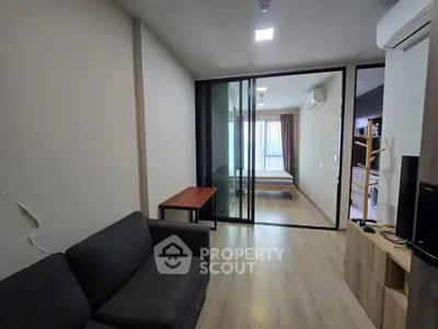 Modern apartment interior with sliding glass doors and cozy living area.