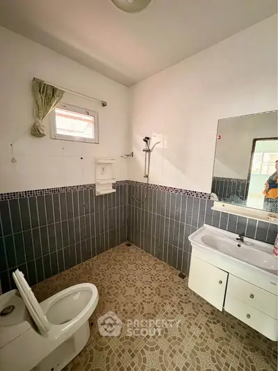 Spacious bathroom with modern fixtures and stylish tile flooring