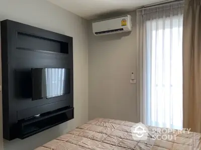 Modern bedroom with wall-mounted TV and air conditioning unit