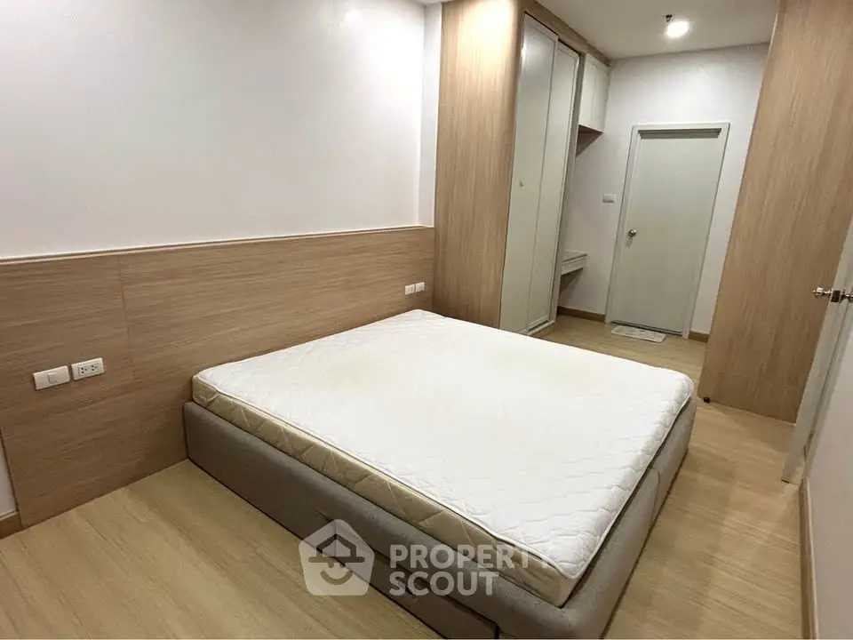 Modern bedroom with minimalist design and built-in storage solutions.