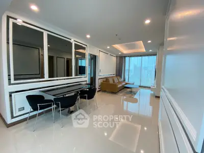 Spacious modern living room with elegant decor and large windows offering city views.