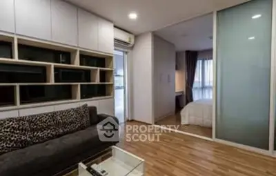 Modern living room with stylish shelving and cozy bedroom view