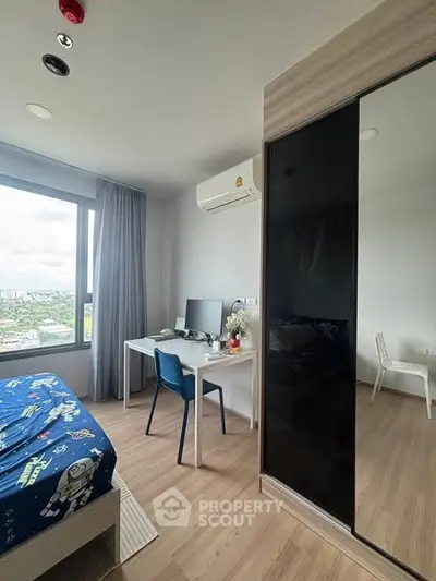 Modern bedroom with large window and sleek furniture, offering a bright and inviting atmosphere.