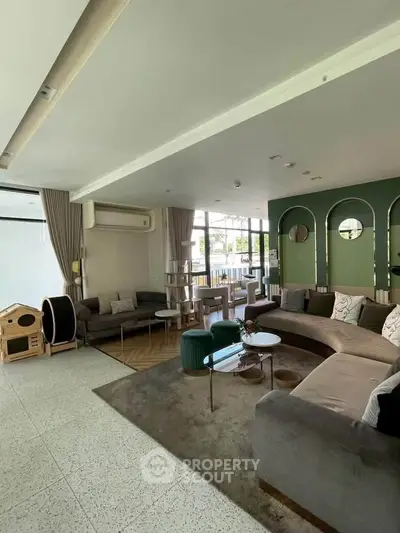 Spacious modern living room with stylish furniture and large windows for natural light.