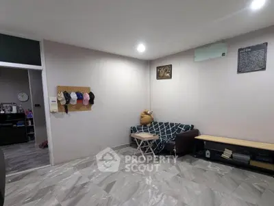 Cozy living room with modern decor and ample seating, perfect for relaxation and entertainment.