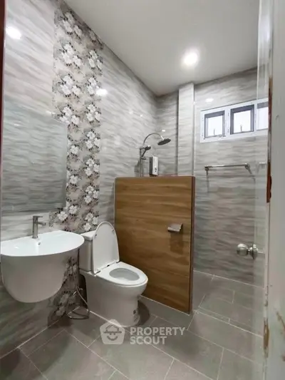 Modern bathroom with stylish tile design and compact layout