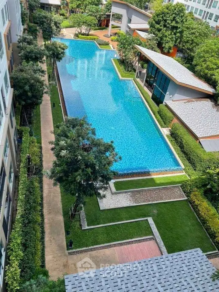Luxurious residential complex with stunning outdoor pool and lush greenery.