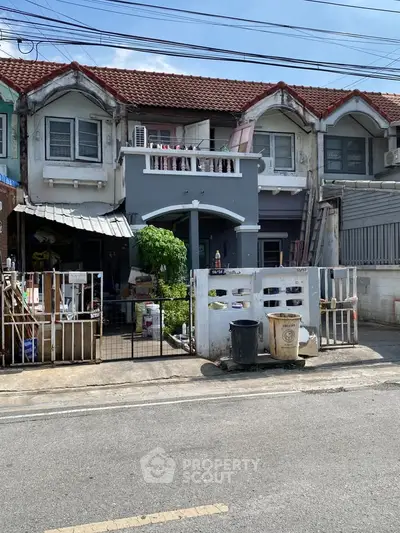 Charming townhouse with unique architectural design and gated entrance, perfect for urban living.