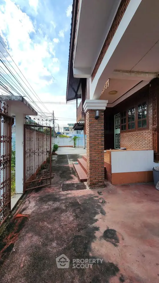 Charming brick exterior of a spacious home with gated entrance and ample driveway space.