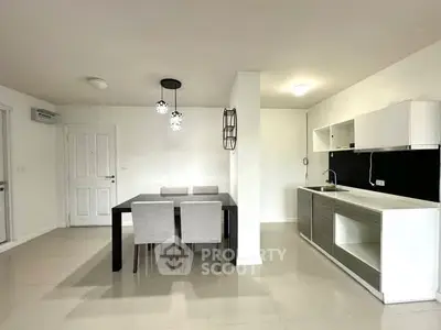 Modern open-layout kitchen and dining area with sleek furnishings