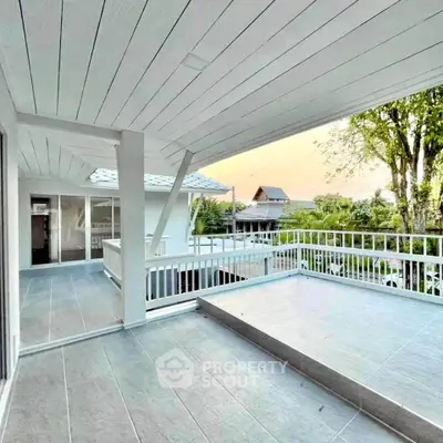 Spacious balcony with modern design and scenic view, perfect for relaxation.