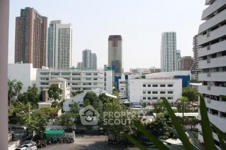 Stunning cityscape view showcasing modern high-rise buildings and lush greenery, perfect for urban living.