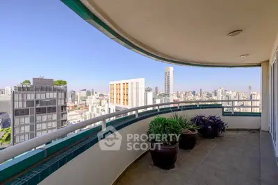 Spacious balcony with stunning city skyline view, perfect for relaxation and entertaining.