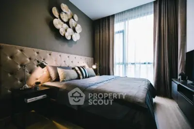 Luxurious bedroom with elegant decor and large window offering natural light.