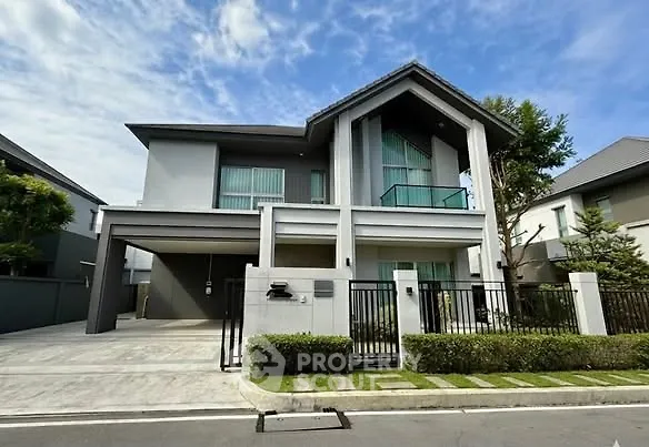 Modern two-story house with sleek design and spacious driveway