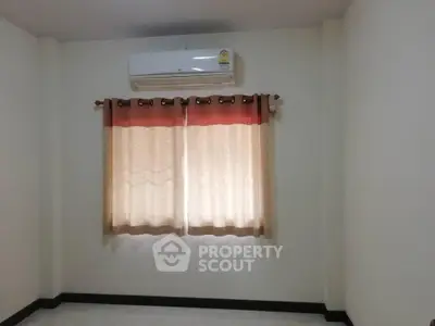 Spacious room with air conditioning and elegant curtains, perfect for comfortable living.