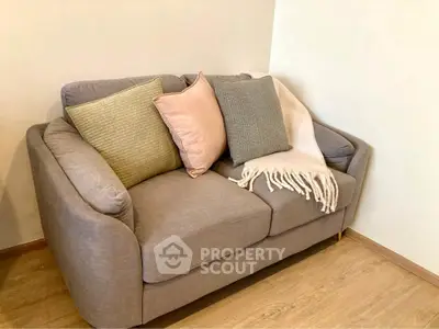 Cozy living room with stylish gray sofa and decorative cushions.