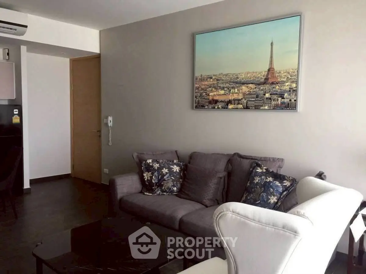 Stylish living room with elegant decor and Paris artwork, perfect for modern urban living.