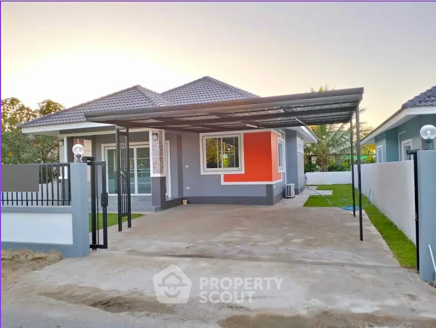 Modern single-story house with carport and landscaped yard