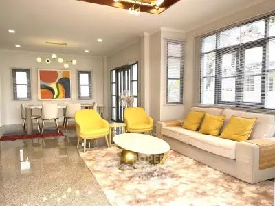 Spacious modern living room with elegant decor and dining area, featuring plush seating and stylish lighting.