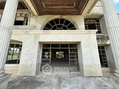 Explore this grand unfinished building with classical columns and expansive windows, perfect for customization.