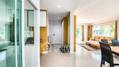 Spacious modern living room with elegant decor and large windows for natural light.