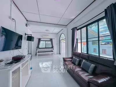 Spacious living room with modern decor and large windows for natural light