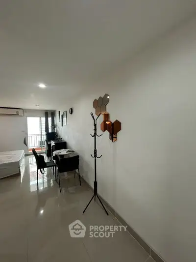 Modern apartment interior with sleek design and natural light, featuring a dining area and stylish decor.