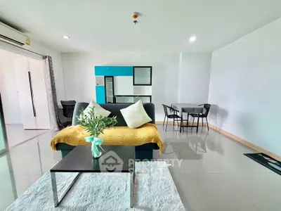 Spacious modern living room with sleek furniture and open layout, perfect for contemporary living.