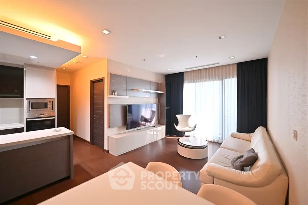 Modern living room with sleek furniture and open kitchen layout