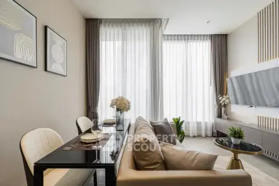 Modern living room with elegant decor and large windows in a stylish apartment.
