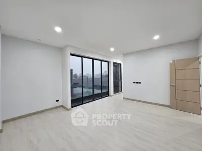 Spacious modern living room with large windows and sleek flooring