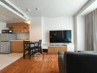 Modern living room with open kitchen and stylish furniture in a cozy apartment