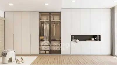 Spacious modern bedroom with sleek built-in wardrobe and elegant decor.