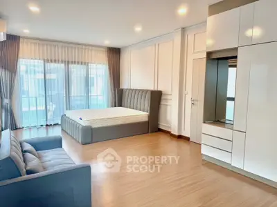 Spacious modern bedroom with elegant design and ample natural light
