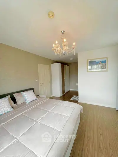 Elegant bedroom with chandelier and modern decor